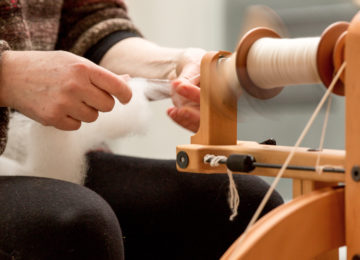 woman spinning guanaco fiber